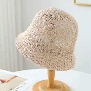 Handmade breathable beige crochet straw bucket hat for summer beach outdoor sun protection.