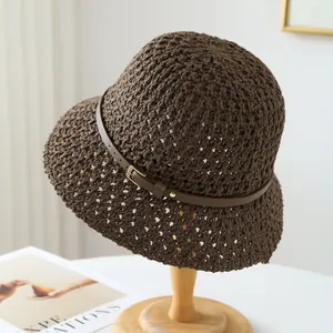 Detailed view of a brown crochet bucket hat featuring a wavy brim and stylish leather belt