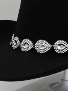 Detailed close-up showing the sparkling crystal rhinestone band on a black felt cowboy hat
