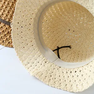 Close-up of hollow crochet straw hat interior with sweatband and adjustable strap