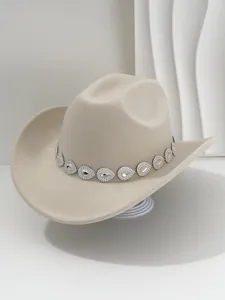Close-up detail of a beige felt cowboy hat featuring a sparkling teardrop rhinestone band