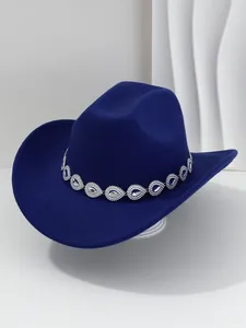 Close-up of a stylish dark blue cowboy hat featuring a sparkling teardrop crystal band.