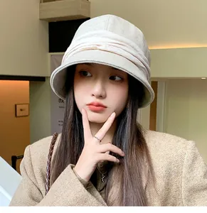 Close-up of a stylish pleated wool bucket hat in beige for winter vintage outfits