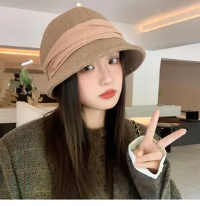 Stylish model wearing a vintage brown pleated felt bucket hat for autumn winter season