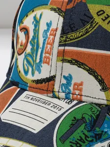 Detailed close-up of vintage print pattern and stitching on a canvas baseball cap