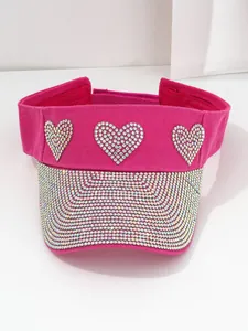 Detailed view of rose red visor hat with rhinestone heart patterns and brim.
