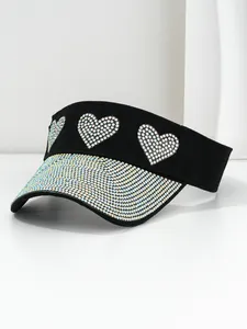 Detail view of a black sun visor with iridescent rhinestone hearts and brim.