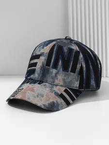 Detailed view of a trendy tie-dye baseball cap featuring bold black letter prints