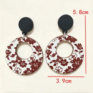 Detail of retro floral print wooden hoop earrings with 5.8cm length dimension