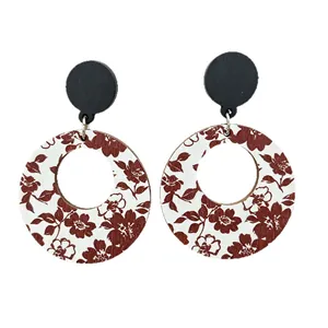 Vintage round hollow wooden drop earrings with burgundy floral print on white background