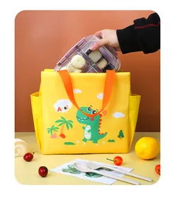 Close-up detail of placing a food container into the cute yellow dinosaur insulated bag.