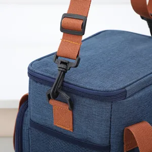 Large capacity blue insulated picnic cooler bag with adjustable brown shoulder strap detail