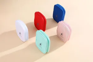 Selection of colorful portable medicine bags for travel storage on warm background
