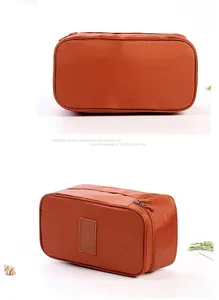 Detailed view of a portable orange travel organizer bag for underwear and toiletries