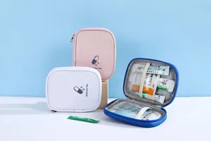 Detailed view of travel medicine bags showing internal mesh pockets and elastic straps