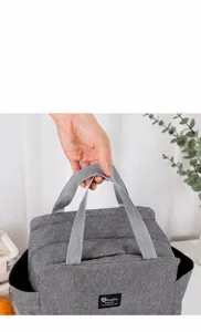 Gros plan de la poignée du sac à lunch isotherme gris avec démonstration