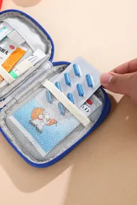 Detail of blue portable medicine bag showing mesh pockets with medical supplies.