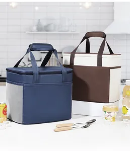 Due grandi borse termiche per il pranzo in blu e marrone su un piano di cucina