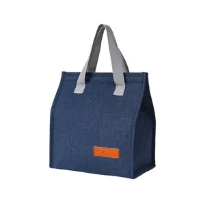 Portable insulated lunch bag in navy blue with durable grey handles for daily use