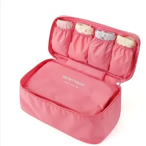 Pink travel underwear organizer pouch with multiple compartments for bras and socks storage