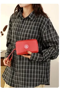 Pochette de téléphone rouge en tissu à trois couches tenue par une jeune femme