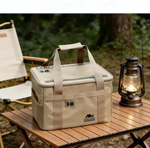 Tactical khaki camping storage bag on a wooden table in an outdoor forest setting.