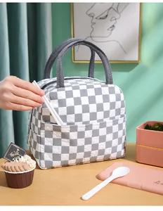 Detailed view of grey and white checkered insulated lunch bag showing front pocket storage