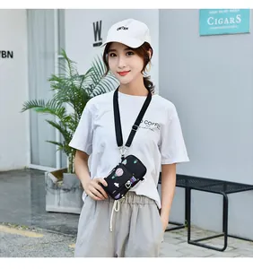 Asian model wearing a compact crossbody phone bag with colorful hot air balloon prints