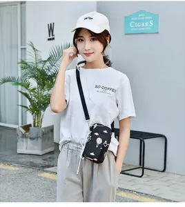 Detailed view of an Asian model wearing a black crossbody phone bag with balloon print.