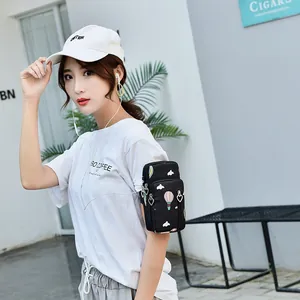 Stylish black printed phone arm bag with hot air balloons pattern worn by young woman outdoors
