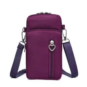 Stylish purple crossbody cell phone bag for women with heart-shaped zipper pull detail