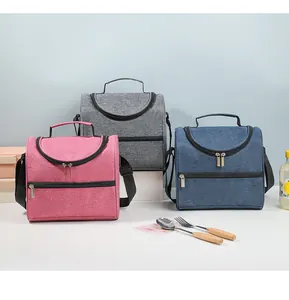 Group of pink, grey, and blue insulated lunch bags with adjustable shoulder straps.