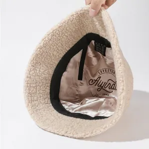 Detailed view of plush sherpa bucket hat with soft satin lining and inner label.