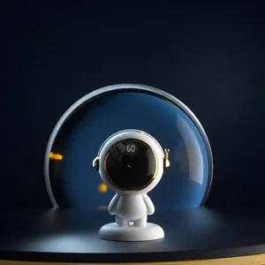 Portable astronaut-shaped cartoon USB rechargeable hand warmer with digital display.
