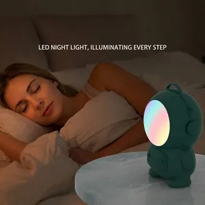 Astronaut LED night light and rechargeable hand warmer in sleeping scene