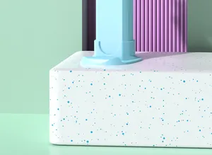 Detailed macro view of a light blue portable fan base on a speckled white platform.