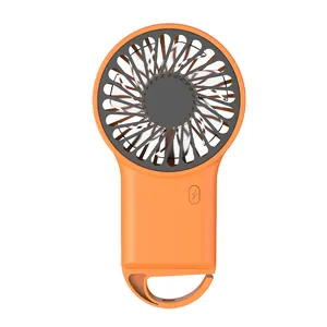 Compact orange handheld mini fan with USB charging and integrated carabiner hook for outdoor use