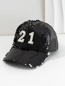 Macro detail of a black sequin baseball cap with pearl and rhinestone number 21