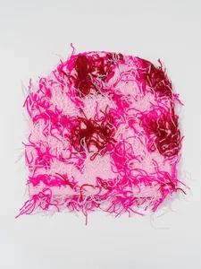 Detail view of pink and magenta distressed camouflage knit beanie with shaggy fuzzy yarn texture