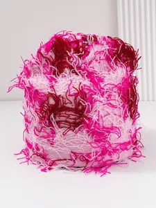 Detailed view of pink distressed knit balaclava with vibrant frayed yarn texture