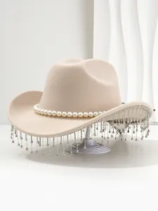Detailed view of beige fedora hat with pearl band and hanging rhinestone tassels