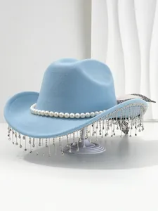 Detail shot of a light blue western hat featuring pearl bands and rhinestone tassels.