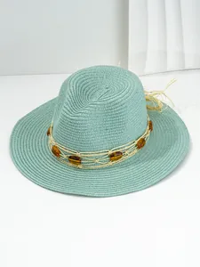Detailed side view of a stylish teal woven straw Panama hat with amber bead band decoration