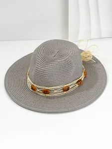 Detailed view of grey Panama straw hat with amber stone band decoration