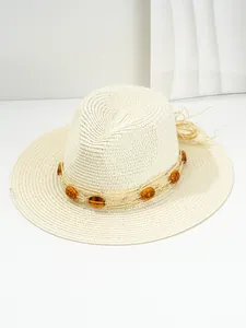 Detailed macro view of woven straw Panama sun hat with amber gemstone decoration