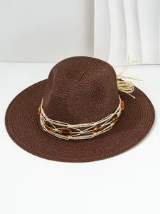 Detailed view of a brown Panama straw hat featuring amber gemstones and woven band