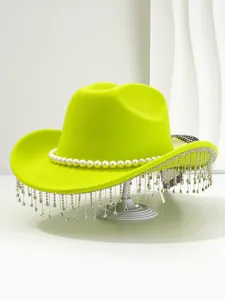 Close-up of vibrant neon yellow cowboy hat decorated with pearls and rhinestone tassels