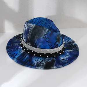 Close-up of blue tie-dye fedora hat with elegant pearl and rhinestone hatband details