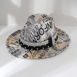 Close-up of stylish tie-dye fedora hat with letter print and pearl rhinestone band