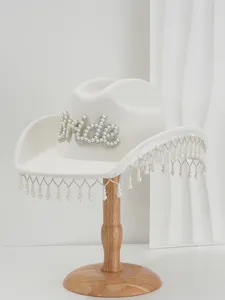 Exquisite white wool bridal cowboy hat featuring pearl Bride lettering and tassel fringe